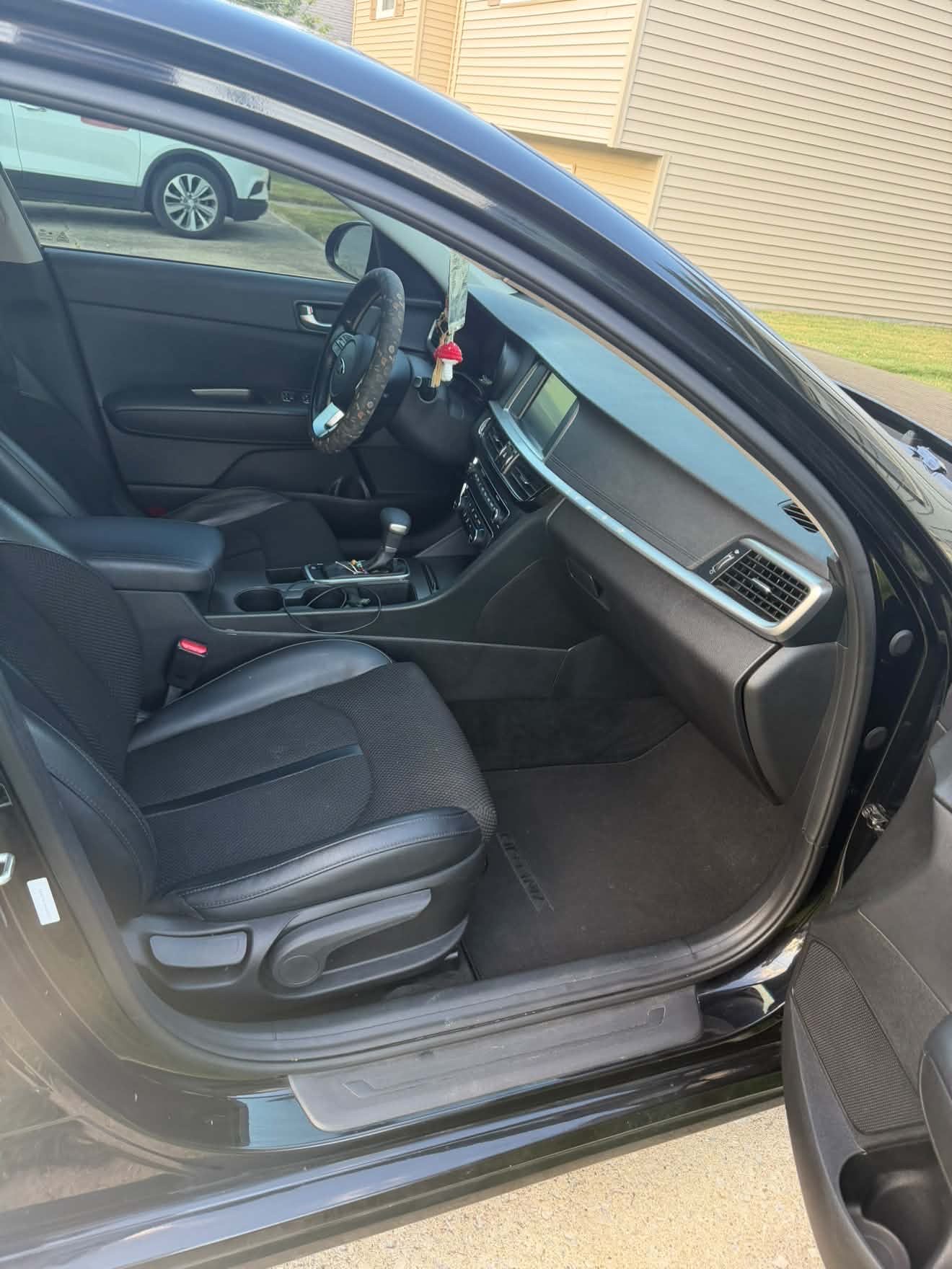Clean black sedan passenger interior after detailing